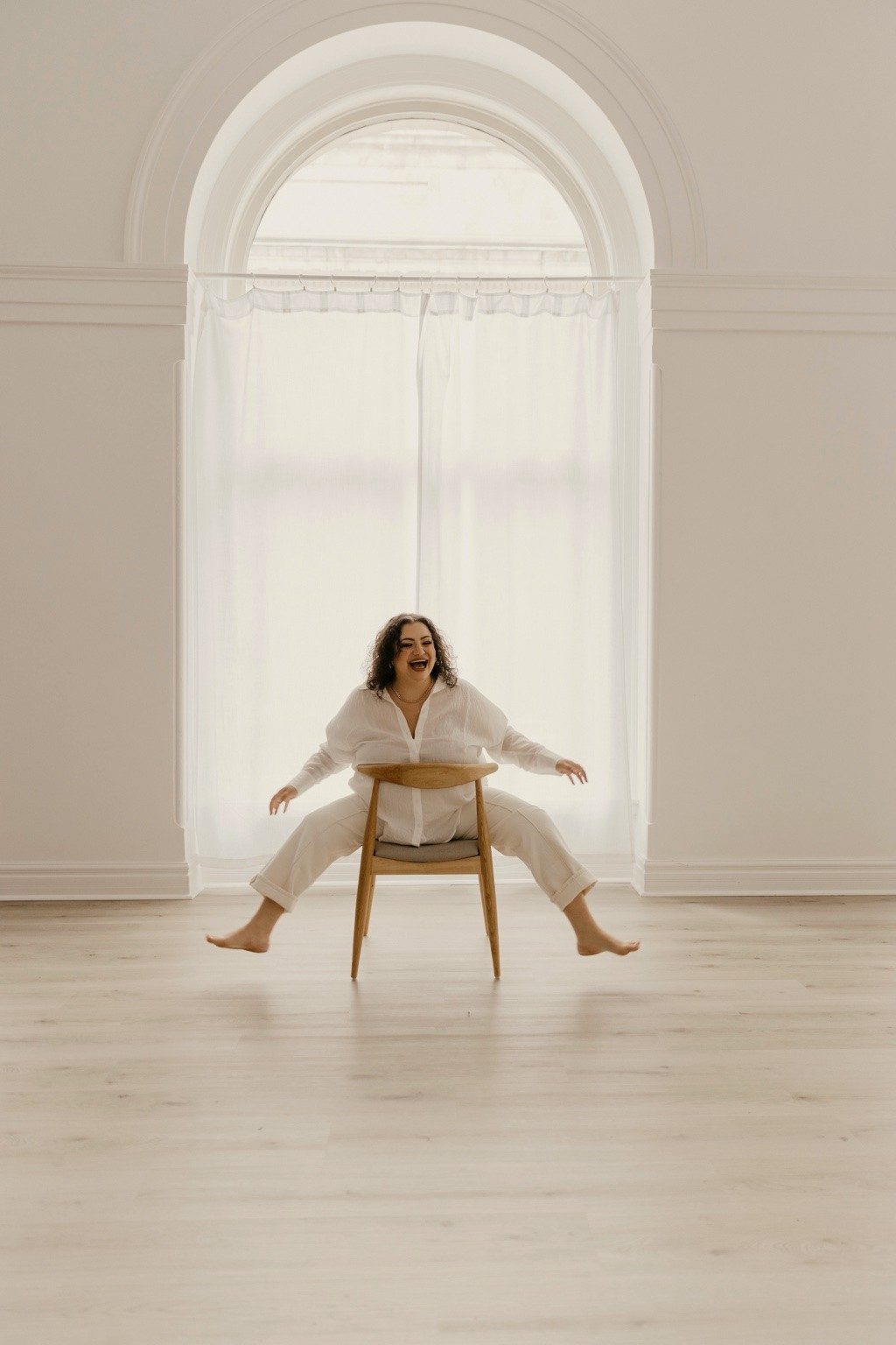 Char, playful portrait by an arched window